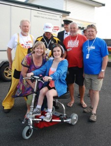 Sydnie Maxwell on her new travel scoot with her mother Maree and members of the Naki Boyz team.