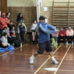 Angus Erueti smacks the ball during an indoor softball game.